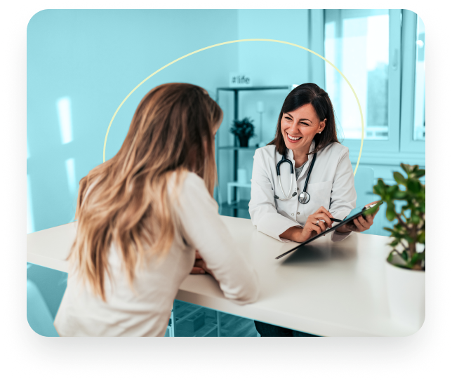 Smiling doctor showing chart to engaged female patient.